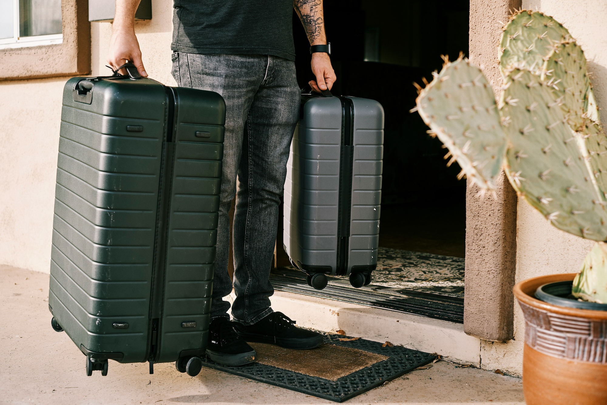 Photo of man carrying big luggages while travelling.